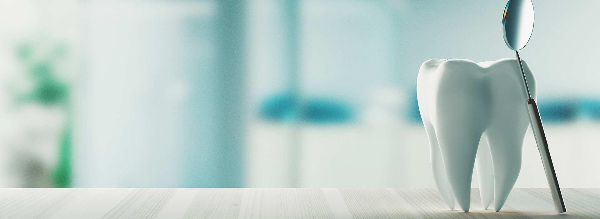 The image shows a toothbrush with bristles in the foreground, and a blurred background that appears to be an indoor setting with a glimpse of a person s arm.